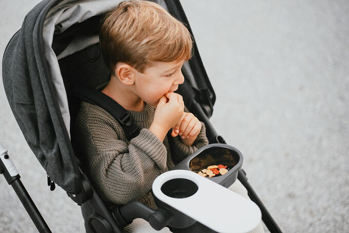 Kid eating in stroller